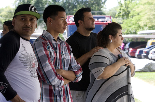 Kim Raff  |  The Salt Lake Tribune
People gather to watch as Salt Lake City firefighters work to put out a fire in an apartment building at the Park City Apartments off of 900 West in Salt Lake City on June 30, 2013.