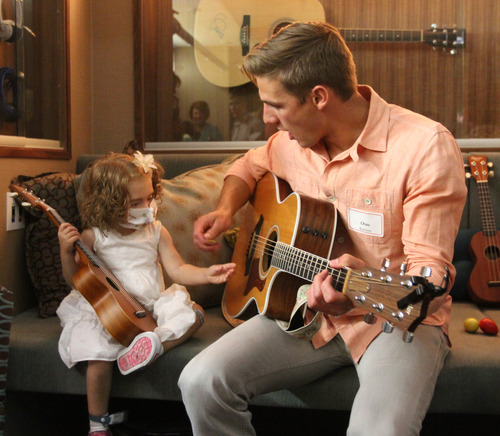 Rick Egan  |  The Salt Lake Tribune
Sophie Barton's brother Chas Barton plays guitar with 3-year-old Alice Fish at Sophie's place at Primary Children's Medical Center, Friday, June 28, 2013. Barb and Steve Young and their Forever Young Foundation paid tribute to Sophie Barton -- a local singer-songwriter who died in 2010 at the age of 17 -- by unveiling the music therapy space.