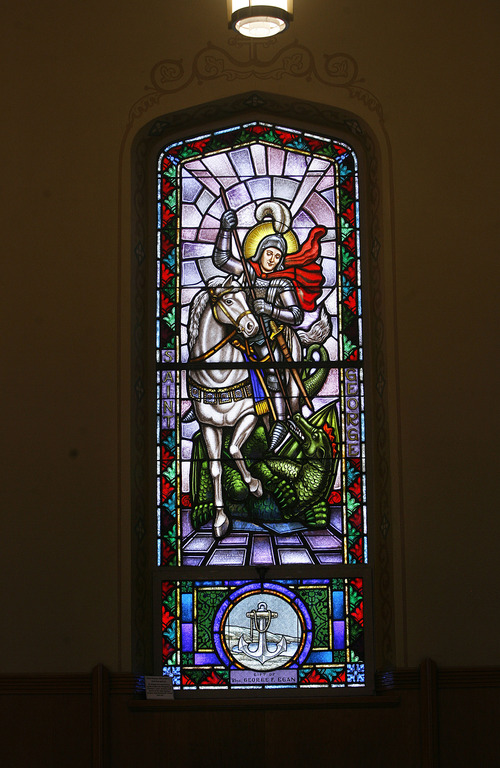Scott Sommerdorf   |  The Salt Lake Tribune
Stained glass of St. George, a Roman soldier who was said to slay a dragon, which caused the people to convert to Christianity. He was later beheaded. The window inside Our Lady of Lourdes Catholic Church.  The church is celebrating its 100th anniversary. Sunday, June 23, 2013.