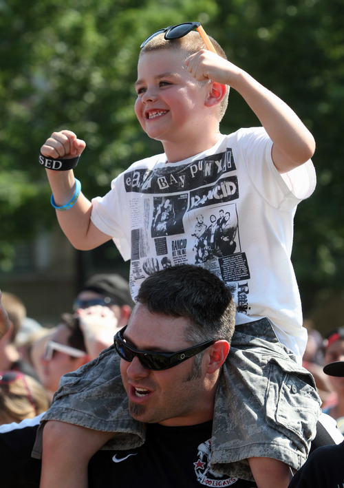 Rick Egan  | The Salt Lake Tribune 

Seven-year-old Rohin Green dances to the Aquabats, on the shoulders of his dad, Shane Green, at the Warped Tour, at the Utah State Fairgrounds, Saturday, June 29, 2013.Seven