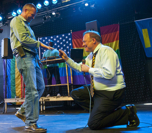 Chris Detrick  |  The Salt Lake Tribune
Sen. Jim Dabakis, D-Salt Lake City, proposes to Stephen Justesen, his boyfriend of over twenty-five years, during a party to show unity, love and celebrate all Utah families at Club Sound Wednesday June 26, 2013.  In historic decisions, the Supreme Court handed gay-rights supporters major victories Wednesday, extending federal rights to same-sex couples and reversing a ban on gay marriage in the nation's largest state.