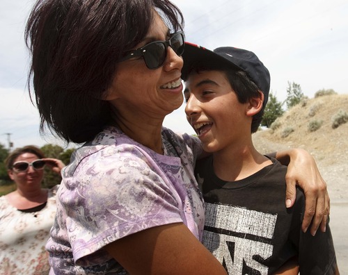 Leah Hogsten  |  The Salt Lake Tribune
Missing hiker Nate Cowsert, 13, gets a hug from his mother, Nettie Cowsert, after he was rescued Wednesday, July 3, 2013 from a rugged Perry Canyon, where they spent the night after becoming lost.