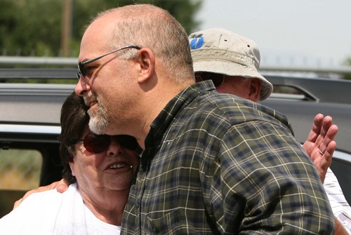 Leah Hogsten  |  The Salt Lake Tribune
Missing hiker David Cowsert gets a hug from his mother, Karen, and father, Roger Wilde, after he, his wife, Holly, her daughter, Mandy, 12, and David's two sons, Polo, 13, and Nate 12, of Perry, were rescued Wednesday, July 3, 2013 from a rugged Perry Canyon, where they spent the night after becoming lost.