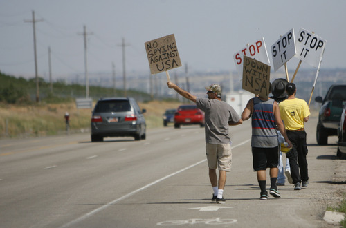 Francisco Kjolseth  |  The Salt Lake Tribune
Opponents of the NSA Data Center protest the center on the 4th of July along Redwood road near the entrance to the new facility.