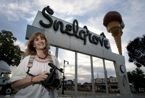 Steve Griffin | The Salt Lake Tribune

Photographer Laurie Bray with the Snelgrove ice cream sign in Sugar House, Utah Tuesday July 2, 2013.