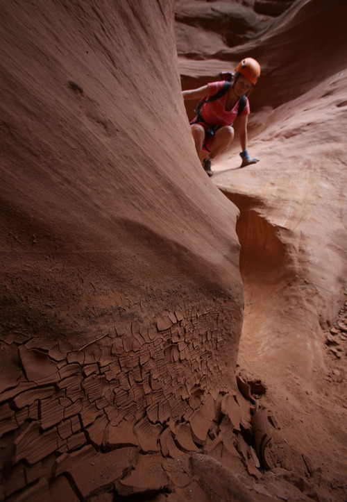 Francisco Kjolseth  |  The Salt Lake Tribune
An extended forecast is always checked to avoid flash floods, which are revealed in the mud as Kristin Wold of Portland Oregon navigates a small drop in one of the many slot canyons in southern Utah.