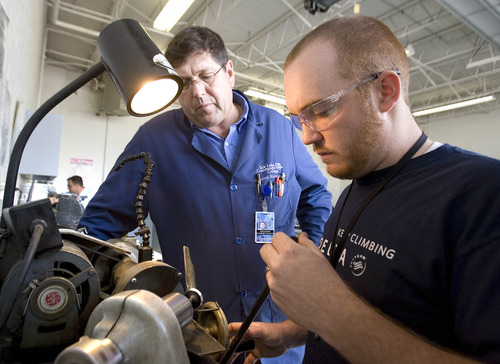 Paul Fraughton  |  The Salt Lake Tribune
Instructor Todd Baird watches as Brandon Heywood refaces a valve from an aircraft engine. Brandon is taking a class in reciprocating aircraft engine rebuilding at Salt Lake Community College's Airport Center.