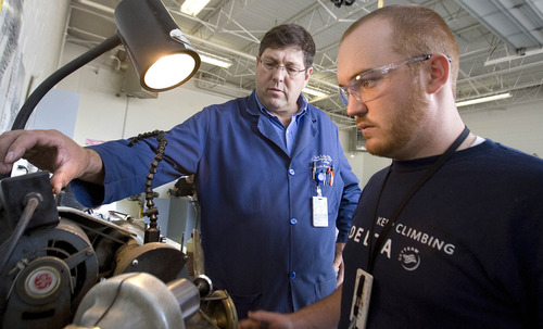 Paul Fraughton  |  The Salt Lake Tribune
Instructor Todd Baird watches as Brandon Heywood refaces a valve from an aircraft engine. Brandon is taking a class in reciprocating aircraft engine rebuilding at Salt Lake Community College's Airport Center.