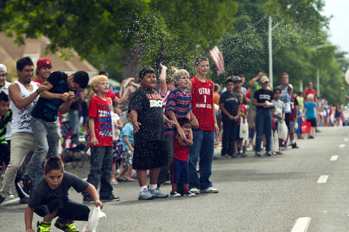 Chris Detrick  |  The Salt Lake Tribune
Children are sprayed with water during the 4th of July parade in Moroni Thursday July 4, 2013.