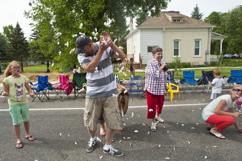 Chris Detrick  |  The Salt Lake Tribune
Salt water taffy from Sweet Candy Company is thrown to the crowd during the 4th of July parade in Moroni Thursday July 4, 2013. About 925 pounds of taffy was given away during the parade.