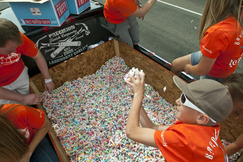 Chris Detrick  |  The Salt Lake Tribune
Keyton Wright, 10, throws a hand full of salt water taffy from Sweet Candy Company to the crowd during the 4th of July parade in Moroni Thursday July 4, 2013. About 925 pounds of taffy was given away during the parade.