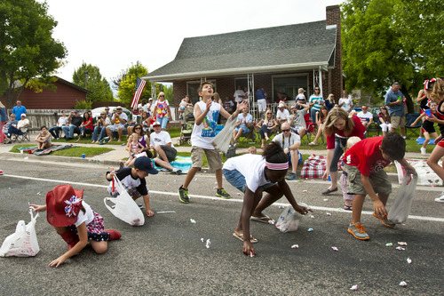 Chris Detrick  |  The Salt Lake Tribune
Children collect salt water taffy from Sweet Candy Company during the 4th of July parade in Moroni Thursday July 4, 2013. About 925 pounds of taffy was given away during the parade.
