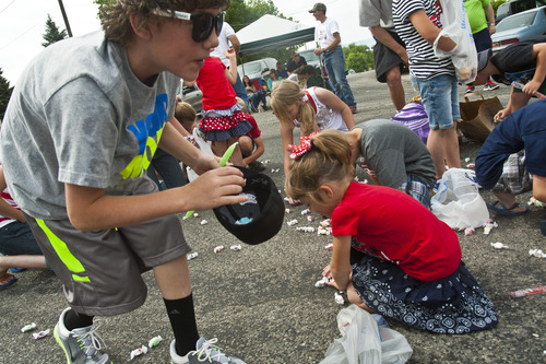 Chris Detrick  |  The Salt Lake Tribune
Children collect salt water taffy from Sweet Candy Company during the 4th of July parade in Moroni Thursday July 4, 2013. About 925 pounds of taffy was given away during the parade.