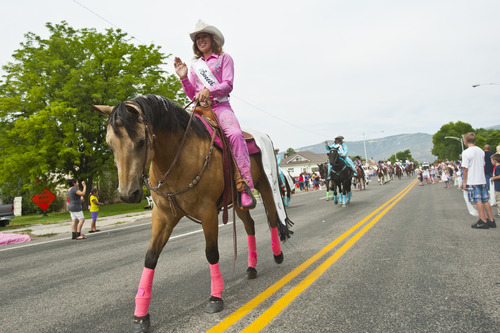Chris Detrick  |  The Salt Lake Tribune
Sanpete County Cowboy Sweetheart Queen Megan Brotherson rides her horse during the 4th of July parade in Moroni Thursday July 4, 2013.