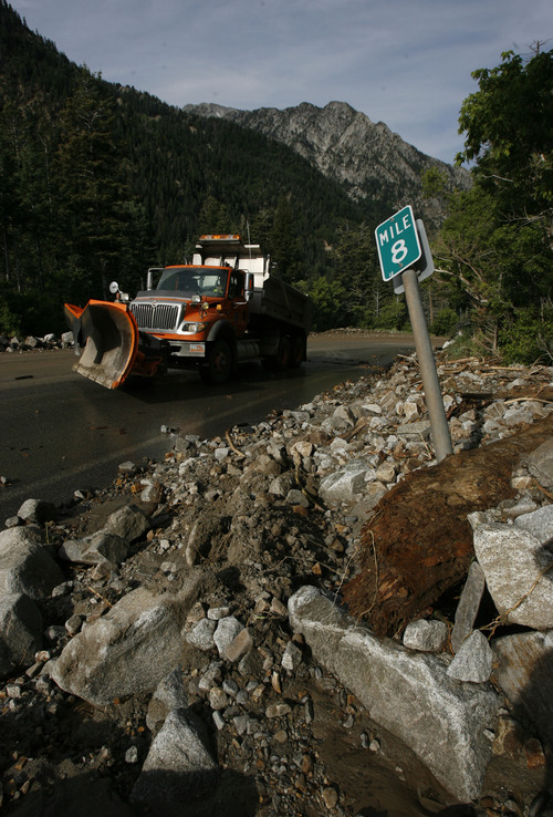 Francisco Kjolseth  |  The Salt Lake Tribune
Crews clean up close to a dozen sections of Little Cottonwood Canyon from Tanners Flat campground and below that were blown out by rock debris following the violent rainstorm that started in the early hours on Friday, July 5, 2013.