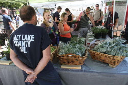 Rick Egan  |  The Salt Lake Tribune
Jail inmates sell vegetables at the county jail booth at the Farmers Market in Pioneer Park in June.