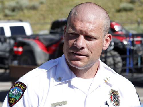 Al Hartmann  |  The Salt Lake Tribune
Assistant Fire Chief Spencer Edwards of Lone Peak Fire Department speaks to the media from Tibble Fork Reservoir parking lot in American Fork Canyon Monday July 8 about the the recovery of two injured men whose helicopter crashed and rolled after hitting a hill high up in the mountains near the Utah-Salt Lake County line.  He said that were able to extricate themselves from the wreck and use a cell phone to call for help about 8:30 a.m.  An AirMed helicopter with search and rescue members aboard was responding to the men in the rugged high country about five miles away.
