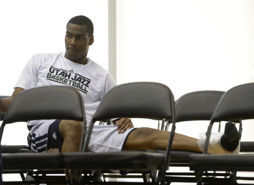 Utah Jazz guard Alec Burks sits behind the bench with ice on his foot during the second half of an NBA Orlando Pro Summer League game against the Miami Heat in Orlando, Fla., Sunday, July 7, 2013. (Special to the Tribune/Phelan M. Ebenhack)