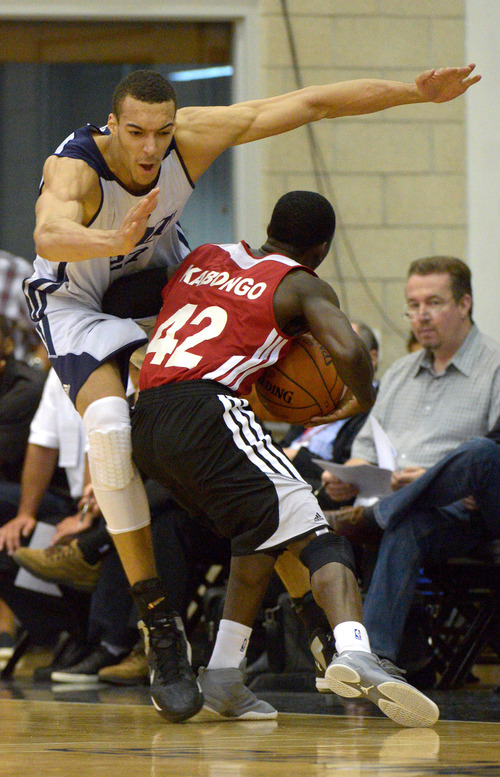 Utah Jazz center Rudy Gobert, left, collides with Miami Heat guard Myck Kabongo (42) during the first half of an NBA Orlando Pro Summer League game in Orlando, Fla., Sunday, July 7, 2013. (Special to the Tribune/Phelan M. Ebenhack)