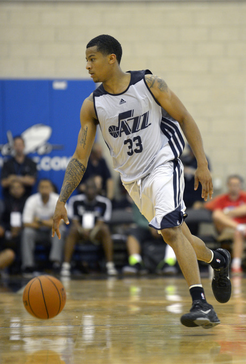 Utah Jazz guard Trey Burke (33) pushes the ball up the court during the second half of an NBA Orlando Pro Summer League game against the Miami Heat in Orlando, Fla., Sunday, July 7, 2013. (Special to the Tribune/Phelan M. Ebenhack)