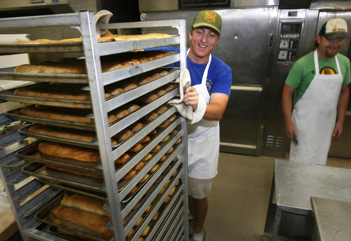 Scott Sommerdorf  |  The Salt Lake Tribune
Paul Serpe, left, wheels out fresh loaves as Brent Whitford, right, of Red Bicycle Breadworks, watches in Park City, Sunday, July 7, 2013. For some businesses the Park Silly Sunday Market is a chance to try out their products and see if the public likes it. The Park Silly Sunday Market is celebrating its fifth season and 100th market on Historic Main Street.