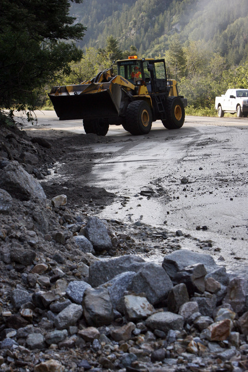 Francisco Kjolseth  |  The Salt Lake Tribune
Crews clean up close to a dozen sections of Little Cottonwood Canyon from Tanners Flat campground and below that were blown out by rock debris following the violent rain storm that started in the early hours on Friday, July 5, 2013.