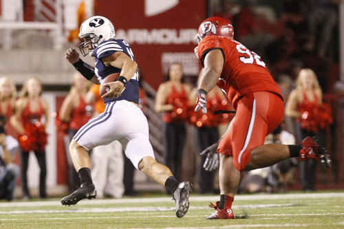 Chris Detrick  |  The Salt Lake Tribune
Brigham Young Cougars quarterback Riley Nelson (13) runs away from Utah Utes defensive tackle Star Lotulelei (92) during the first half of against BYU at Rice-Eccles Stadium Saturday September 15, 2012.
