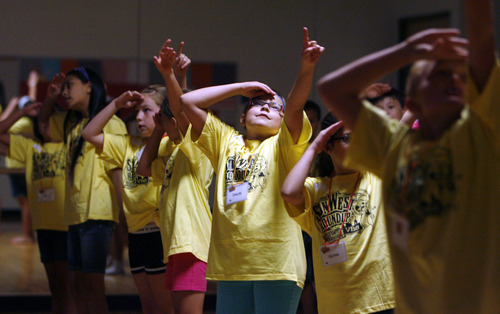 Francisco Kjolseth  |  The Salt Lake Tribune
Dancing to the words "we're going to ride with Jesus Christ - yee haw!" the Western themed Vacation Bible School for St. John the Baptist Catholic Church gets underway at Juan Diego Catholic High School in Draper.