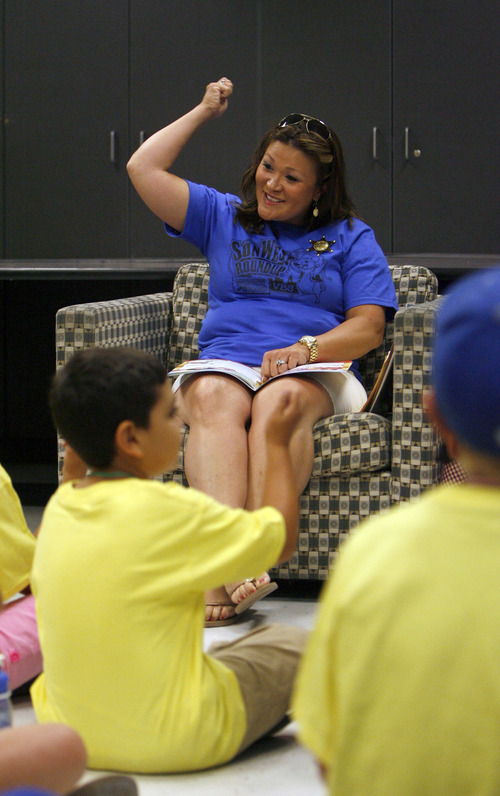 Francisco Kjolseth  |  The Salt Lake Tribune
Judy Robins maintains a Western themes as she greets kids with a "howdy, pardners!" before reading a Bible story about Moses' birth to Vacation Bible School students for St. John the Baptist Catholic Church. Kids ranging from kindergarten to sixth grade started their week long camp at  Juan Diego Catholic High School in Draper.