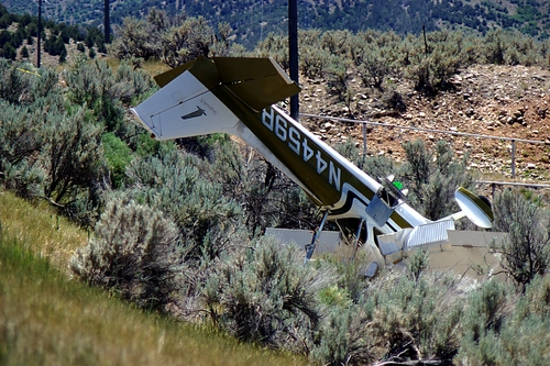 Donald W. Meyers  |  The Salt Lake Tribune 
Utah County Sheriff's Office personnel investigate the crash of a two-seat aircraft on U.S. Highway 89 south of Birdseye Thursday, June 27, 2013. Sheriff's Lt. Shawn Chipman said the pilot, who was critically injured in the crash, radioed the Spanish Fork airport that his cabin was filling with smoke and was going to attempt an emergency landing on the road. A passenger in the plane was killed on impact, Chipman said. The crash blocked traffic until 1:20 p.m.