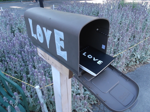One of two "Mailbox Diaries," into which people can write anonymously their thoughts on love or grief, are mounted in front of the City-County Building at the Utah Arts Festival. (photo by Sean P. Means  |  The Salt Lake Tribune)