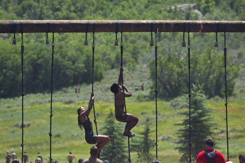 Chris Detrick  |  The Salt Lake Tribune
Competitors climb up ropes during the Utah Spartan Beast Race at Soldier Hollow Saturday June 29, 2013. The 12-mile race included obstacles like mud pits with barbed wire, rope climbs, jumping over fire and climbing an eight-foot wall.