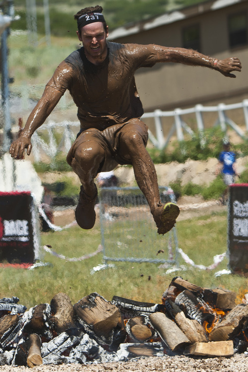 Chris Detrick  |  The Salt Lake Tribune
A competitor jump over a bon fire during the Utah Spartan Beast Race at Soldier Hollow Saturday June 29, 2013. The 12-mile race included obstacles like mud pits with barbed wire, rope climbs, jumping over fire and climbing an eight-foot wall.