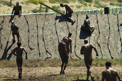Chris Detrick  |  The Salt Lake Tribune
Competitors use a rope to climb up a wall during the Utah Spartan Beast Race at Soldier Hollow Saturday June 29, 2013. The 12-mile race included obstacles like mud pits with barbed wire, rope climbs, jumping over fire and climbing an eight-foot wall.