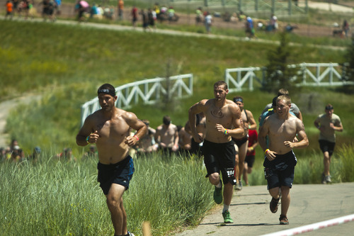 Chris Detrick  |  The Salt Lake Tribune
Competitors run during the Utah Spartan Beast Race at Soldier Hollow Saturday June 29, 2013. The 12-mile race included obstacles like mud pits with barbed wire, rope climbs, jumping over fire and climbing an eight-foot wall.