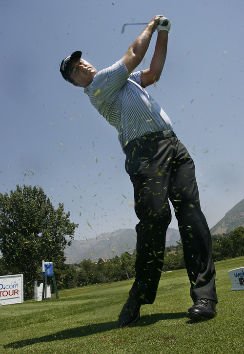 Scott Sommerdorf   |  The Salt Lake Tribune
Michael Putnam releases a cloud of grass clippings as he takes a practice swing on the par 3 18th tee at Willow Creek Country Club, Wednesday, July 10, 2013.