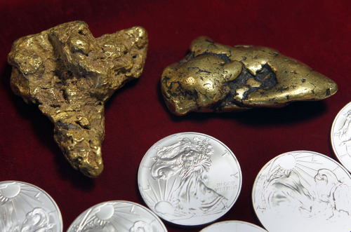 Al Hartmann  |  The Salt Lake Tribune
An Alaskan 16-ounce gold nugget, left, and an 8-ounce Klondike nugget are for sale along with 1-ounce Silver Eagles at All About Coins in Salt Lake City. For a good many Utahns, gold and silver coins and bullion haven't lost their luster despite the recent sharp declines in the prices of the precious metals.