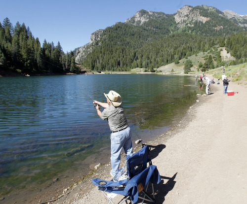 Al Hartmann  |  The Salt Lake Tribune
A fisherman casts into the clear water of Tibble Fork Reservoir in American Fork Canyon on Friday, June 21, 2013. The U.S. Forest Service is overhauling its recreational fee program for American Fork Canyon and Mirror Lake Scenic Byway. Instead of charging everyone who drives into these areas, the Forest Service proposes charging only those who use the recreational amenities.