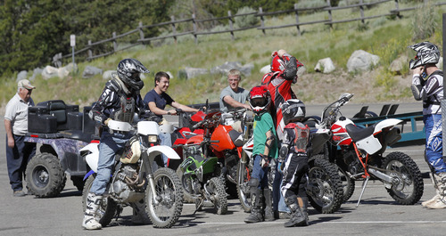 Al Hartmann  |  The Salt Lake Tribune
Dirt bike riders suit up at the Tibble Fork Reservoir parking lot in American Fork Canyon. The reservoir has the largest parking lot in the canyon and it's busy with bicyclists, fishermen, hikers, picnickers and off-road vehicle riders. The U.S. Forest Service is overhauling its recreational fee program for American Fork Canyon and Mirror Lake Scenic Byway. Instead of charging everyone who drives into these areas, the Forest Service proposes charging only those who use the recreational amenities.