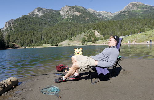 Al Hartmann  |  The Salt Lake Tribune
Nick Olson of Salt Lake City relaxes with a fishing line in the water at Tibble Fork Reservoir in American Fork Canyon Friday June 21, 2013. He said that he doesn't really care if he catches a fish. He's up there for the clean air with his family. "This is where I get my peace," he said. The U.S. Forest Service is overhauling its recreational fee program for American Fork Canyon and Mirror Lake Scenic Byway. Instead of charging everyone who drives into these areas, the Forest Service proposes charging only those who use the recreational amenities.