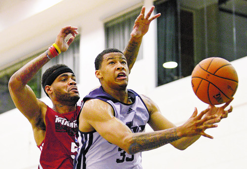 Utah Jazz guard Trey Burke, right, puts up a shot in front of Miami Heat guard D.J. Kennedy during the first half of an NBA Orlando Pro Summer League game in Orlando, Fla., Sunday, July 7, 2013. (Special to the Tribune/Phelan M. Ebenhack)