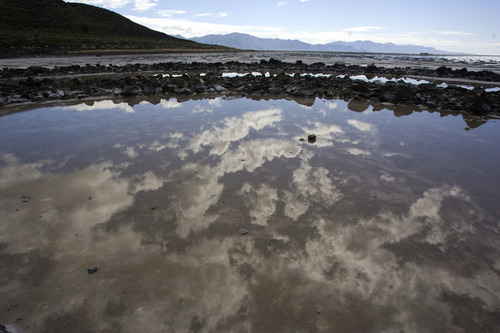 The clouds are reflected in the spiral jetty along the northern portion of the Great Salt Lake Tueday, May 5, 2009. The jetty was created by artist Robert Smithson in 1970. Black basalt rock was used to create a coil 1,500 feet long. (FOR WHARTONS WEST DESERT STORY). Jim Urquhart/The Salt Lake Tribune; 5/05/09