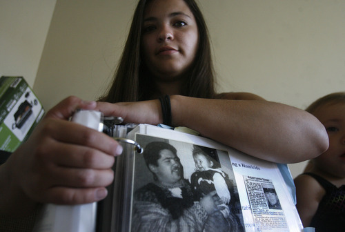 Scott Sommerdorf   |  The Salt Lake Tribune
Derinda Durazo holds a binder with a photo of her father Lonnie Durazo holding her when she was just one year old. She is 23 now, as she posed for this photo in West Valley City, Friday, July 12, 2013.