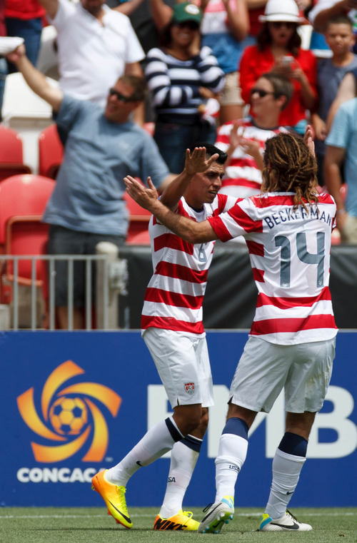 Trent Nelson  |  The Salt Lake Tribune
USA's Joe Corona celebrates his goal with teammate Kyle Beckerman as the United States faces Cuba in CONCACAF Gold Cup soccer at Rio Tinto Stadium in Sandy, Saturday July 13, 2013.