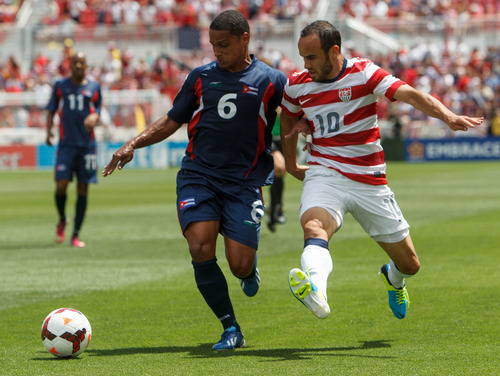 Trent Nelson  |  The Salt Lake Tribune
Cuba's Yoel Colome and USA's Landon Donovan chase down the ball as the United States faces Cuba in CONCACAF Gold Cup soccer at Rio Tinto Stadium in Sandy, Saturday July 13, 2013.