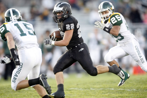 Chris Detrick  |  The Salt Lake Tribune
Riverton's Jake Simonich (22) runs past Kearns' Jeremy Frieze (15) and Kearns' Will Sprowls (25) during the first half of the game at Riverton High School Thursday September 13, 2012.  Riverton is winning the game 27-0.