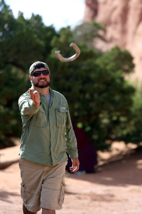 Francisco Kjolseth  |  The Salt Lake Tribune
Brett Prettyman puts his horseshoeing mad skills to the test as he challenges friends in a smack talking tournament while camping in Arches National Park recently.