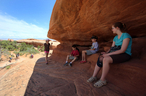 Francisco Kjolseth  |  The Salt Lake Tribune
Taking a break from the heat, Mira Tueller, 5, Teo Droguett, 8, Everett Tueller, 9, and Sydnee Sartor, 13, from left, find a small outcropping to call their own while hiking in Arches.