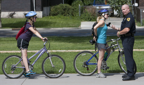 Steve Griffin | The Salt Lake Tribune


SLCPD detective Rick Wall stops Gracie James and her stepmother, Gretchen James to give them each a ticket for playing safe by wearing helmets and following traffic rules as they bike in Liberty Park in Salt Lake City, Utah Monday July 15, 2013. The ticket Wall gave the pair is good for a six inch sandwich at Subway. SLCPD and other Utah law enforcement agencies will be give children the tickets for being safe throughout the summer.