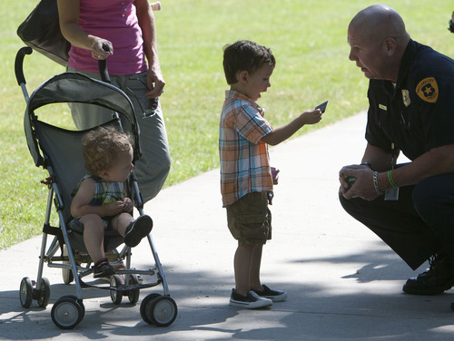 Steve Griffin | The Salt Lake Tribune


Three-year-old Nolan Belliveau reacts with amazement as he gets a ticket from SLCPD detective Rick Wall for playing safely in Liberty Park with his mother, Silvana Belliveau, and his 16-month-old brother Miles.in Salt Lake City, Utah Monday July 15, 2013. The ticket Wall gave Belliveau is good for a six inch sandwich at Subway. SLCPD and other Utah law enforcement agencies will be give children the tickets for being safe throughout the summer.